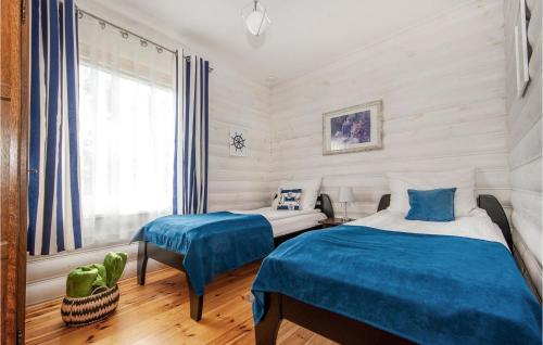 a bedroom with two beds and a window at Awesome Apartment In Jarosawiec With Wifi And 1 Bedrooms in Jarosławiec