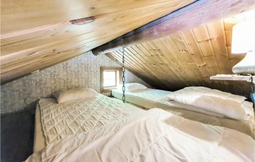 two beds in a room with wooden ceilings at Amazing Home In Munka-ljungby With Wifi in Munka-Ljungby