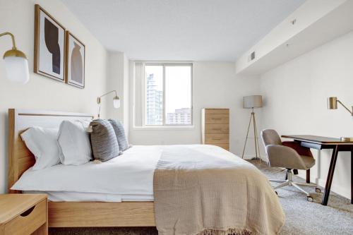 a white bedroom with a bed and a desk at Bethesda 1BR w Concierge Gym WD nr Metro WDC-332 in Bethesda
