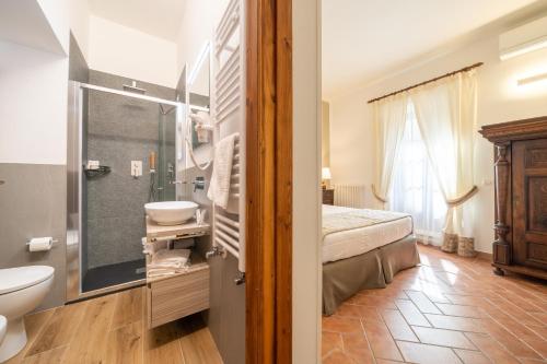 a bathroom with a bed and a toilet and a sink at Affittacamere Valentina in Orvieto