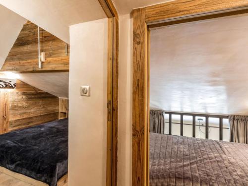 a bedroom with a bed in a room with a window at Appartement luxe avec wifi et parking sur les pistes au cœur de Val-d'Isère - FR-1-694-133 in Val dʼIsère