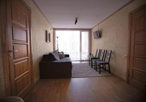 a living room with a couch and a table at Kempings Ozolkalns in Cēsis