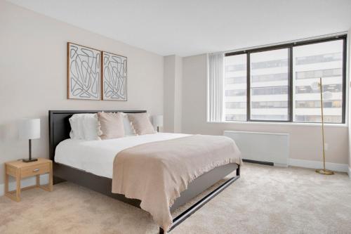 a white bedroom with a large bed and a window at Crystal City 1BR w Gym Concierge nr Metro WDC-445 in Arlington