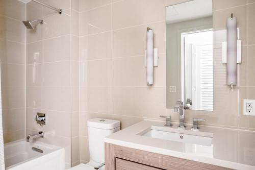 a bathroom with a sink and a toilet and a mirror at Bethesda 1BR w Gym WD Lounge nr Metro WDC-538 in Bethesda