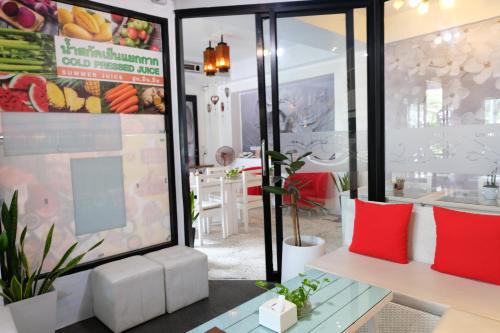 a store with red and white pillows and a table at Baanpoon Apartment in Chaweng