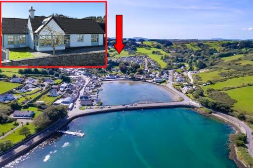 an aerial view of a house with a boat in the water at 4 bedroom Holiday Home In Union Hall, West Cork in Union Hall