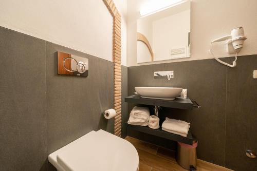 a bathroom with a white toilet and a sink at Affittacamere Valentina in Orvieto