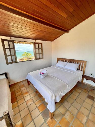 Ένα ή περισσότερα κρεβάτια σε δωμάτιο στο Pousada Casa Feliz Maxaranguape