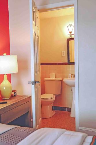 a bathroom with a toilet and a sink at La Posada in Milford