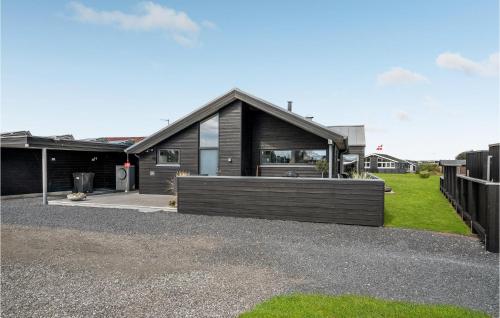 a modern house with a black exterior at Holiday Home Strandgården in Sæby