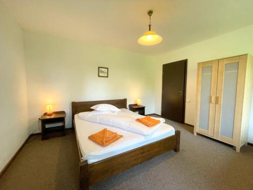 a bedroom with a bed with two candles on it at Pensiunea Cehov in Bran