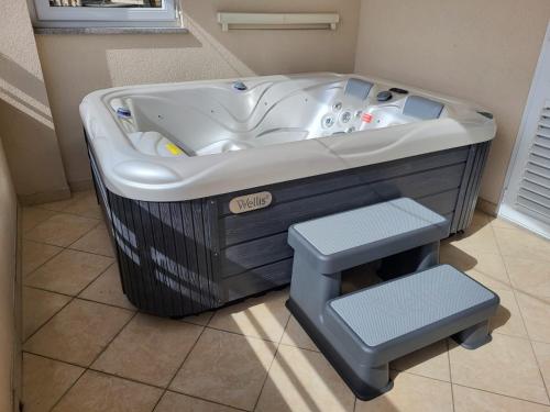 a bath tub in a room with a trash can at Apartment Temza in Krilo