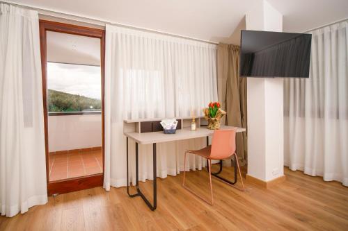 a room with a table and a chair and a window at ARIA - Villa di Campagna in Montecorvino Rovella