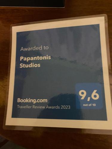 a sign that says awarded to programs and studies at Papantonis Studios in Chrisopigi
