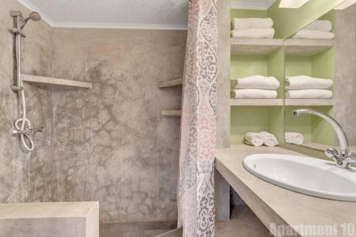 a bathroom with a sink and a shower at Bonaire Oceanfront Apartments in Kralendijk