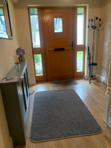a living room with a wooden door and a rug at Lough Rynn-Lord Leitrim in Rivers Town