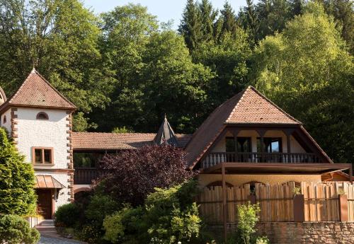 a house with a fence in front of it at LA CHENEAUDIÈRE - Hôtel Spa - Relais & Châteaux - Restaurant étoilé in Colroy-la-Roche