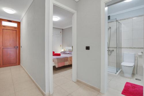 a bedroom with a bed and a bathroom with a toilet at Halcon - Costa del Silencio in Costa Del Silencio