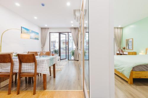 a bedroom and a dining room with a table and chairs at LUCK APART 9 - Hanoi WestLake Balcony Apartment in Hanoi