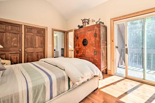a bedroom with a bed and a large window at Modern Catskills Escape on 25 Acres with Deck! in Mountain Dale