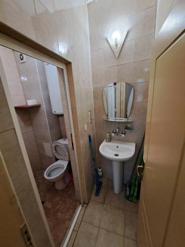a small bathroom with a toilet and a sink at relax in Plovdiv