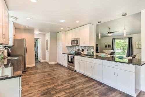 a large kitchen with white cabinets and wood floors at about 3 Mi to Dtwn McKinney Suburban Texas Retreat in McKinney