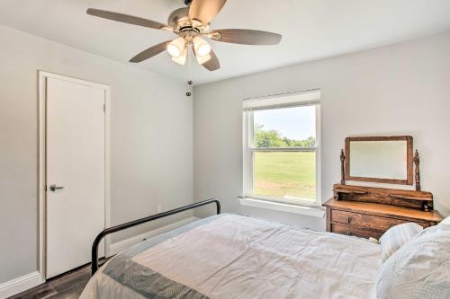 a bedroom with a bed and a ceiling fan at about 3 Mi to Dtwn McKinney Suburban Texas Retreat in McKinney
