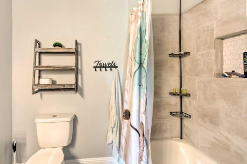 a bathroom with a tub and a toilet and a shower at about 3 Mi to Dtwn McKinney Suburban Texas Retreat in McKinney
