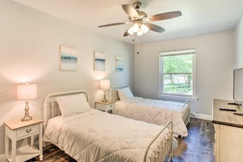 a bedroom with two beds and a ceiling fan at about 3 Mi to Dtwn McKinney Suburban Texas Retreat in McKinney