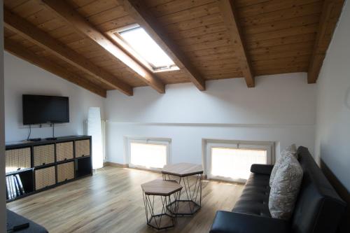 a living room with a couch and a tv at Il Borgo appartamento Luca in Parma