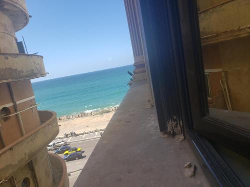 a view of the beach from a window of a building at Stanley Bridge apartment Alexandria in Alexandria