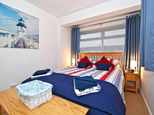 two twin beds in a bedroom with a lighthouse at Barnacles in Alnwick