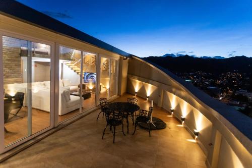a room with a balcony with a bed and a table at Hotel Boutique Rosario Sur in La Paz