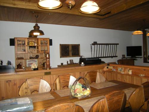 a dining room with a table and chairs and a counter at Gîte Onze in Liessies