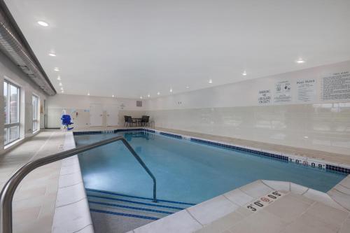 a large swimming pool in a building at Holiday Inn Express & Suites - Ann Arbor - University South, an IHG Hotel in Ann Arbor
