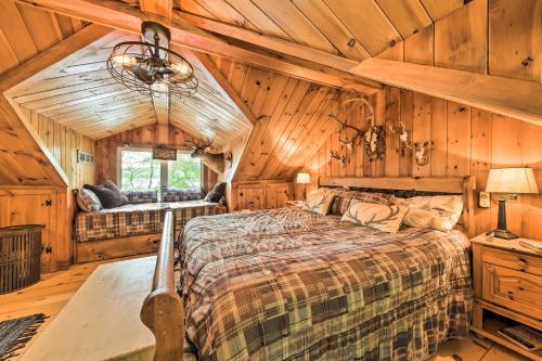 um quarto com uma cama grande num camarote em Beautiful Embden Pond Cabin with Dock and Kayaks! em Embden