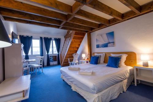 a bedroom with a large bed in a room at Hôtel & Spa du Domaine des Thômeaux, The Originals Relais (Relais du Silence) in Mosnes