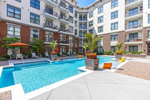 a swimming pool in the courtyard of a apartment building at Cozy and Bright Apartments at Marble Alley Lofts in Downtown Knoxville in Knoxville
