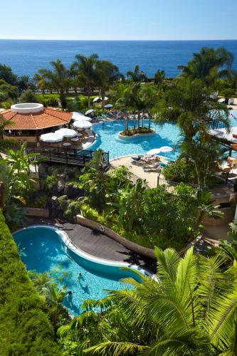 an aerial view of a resort with two pools at Hotel Porto Mare - PortoBay in Funchal