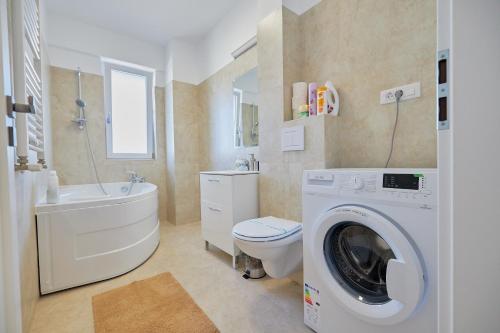 a white bathroom with a washing machine in it at Alessandro Home 7 Luxury Centru Palas Mall Iași Q Residence in Iaşi