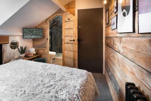 a bedroom with a large white bed and a desk at Windermere Central Hotel - Central Lake District Hotel in Windermere in Windermere