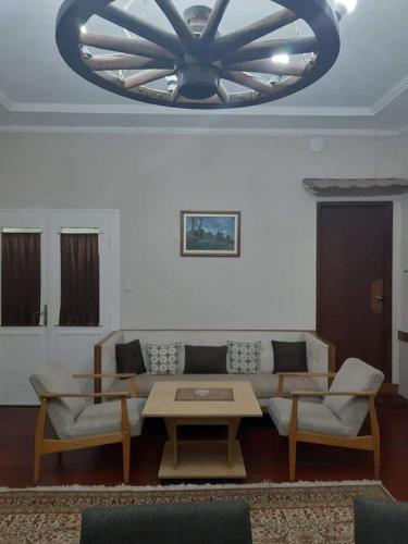 a living room with a couch and a chandelier at **ETNO Vila** - KRUSEVO in Kruševo