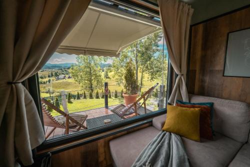 a room with a window with a view of a patio at Tripsylvania Tiny House in Şirnea