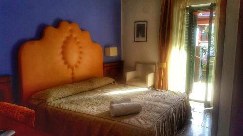 a bedroom with a bed with a teddy bear on it at La Bruca Resort in Scalea