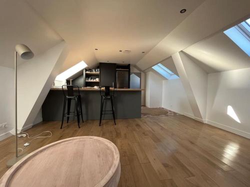 an attic room with a counter and a kitchen with skylights at Sur les toits de Fontainebleau - Hypercentre in Fontainebleau