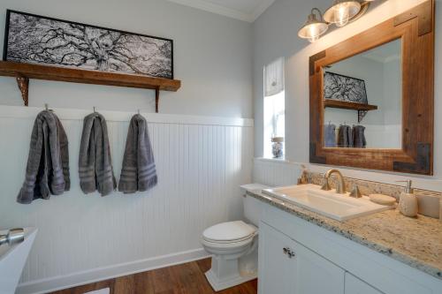 a bathroom with a sink and a toilet and a mirror at Fort Myers Home Near Sanibel Island Causeway in Fort Myers