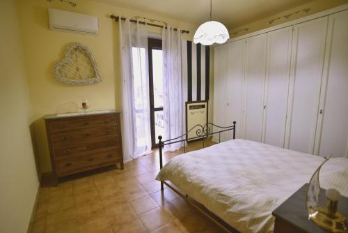 a bedroom with a bed and a dresser and a window at La casina di Settimo in Settimo Torinese