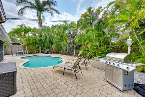 a backyard with a barbecue and a swimming pool at Pelican Nest, Tropical Naples Villa with Pool in Naples