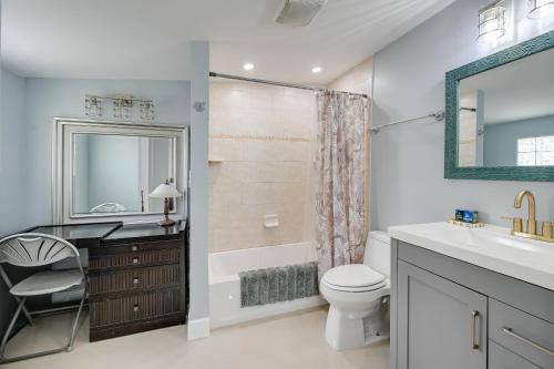 a bathroom with a sink toilet and a mirror at Pelican Nest, Tropical Naples Villa with Pool in Naples