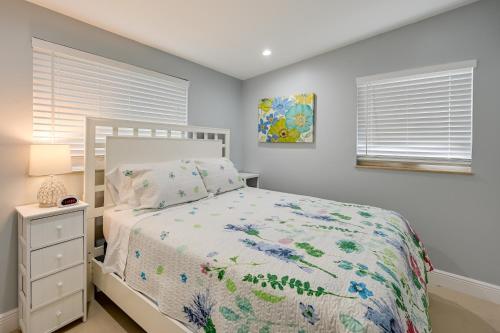 a bedroom with a bed and a night stand and window at Pelican Nest, Tropical Naples Villa with Pool in Naples